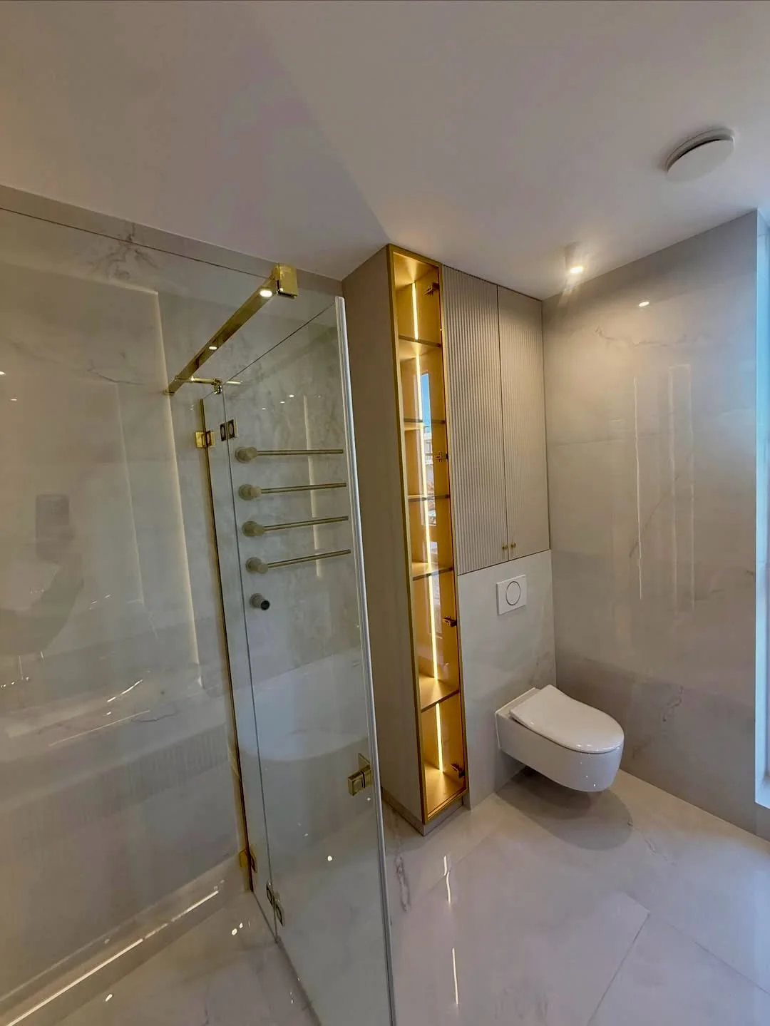 Gold-coloured fittings and carefully finished tile junctions.