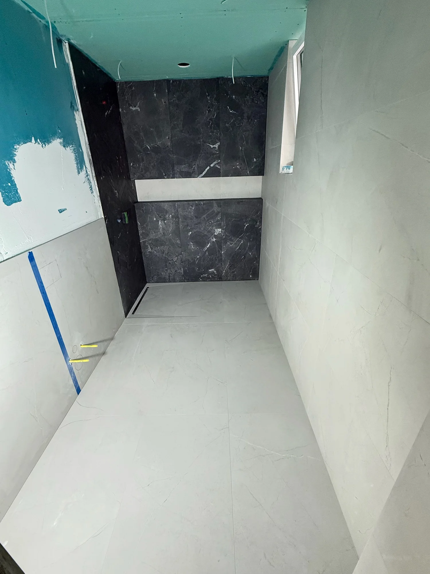 Tiled toilet room during construction.
