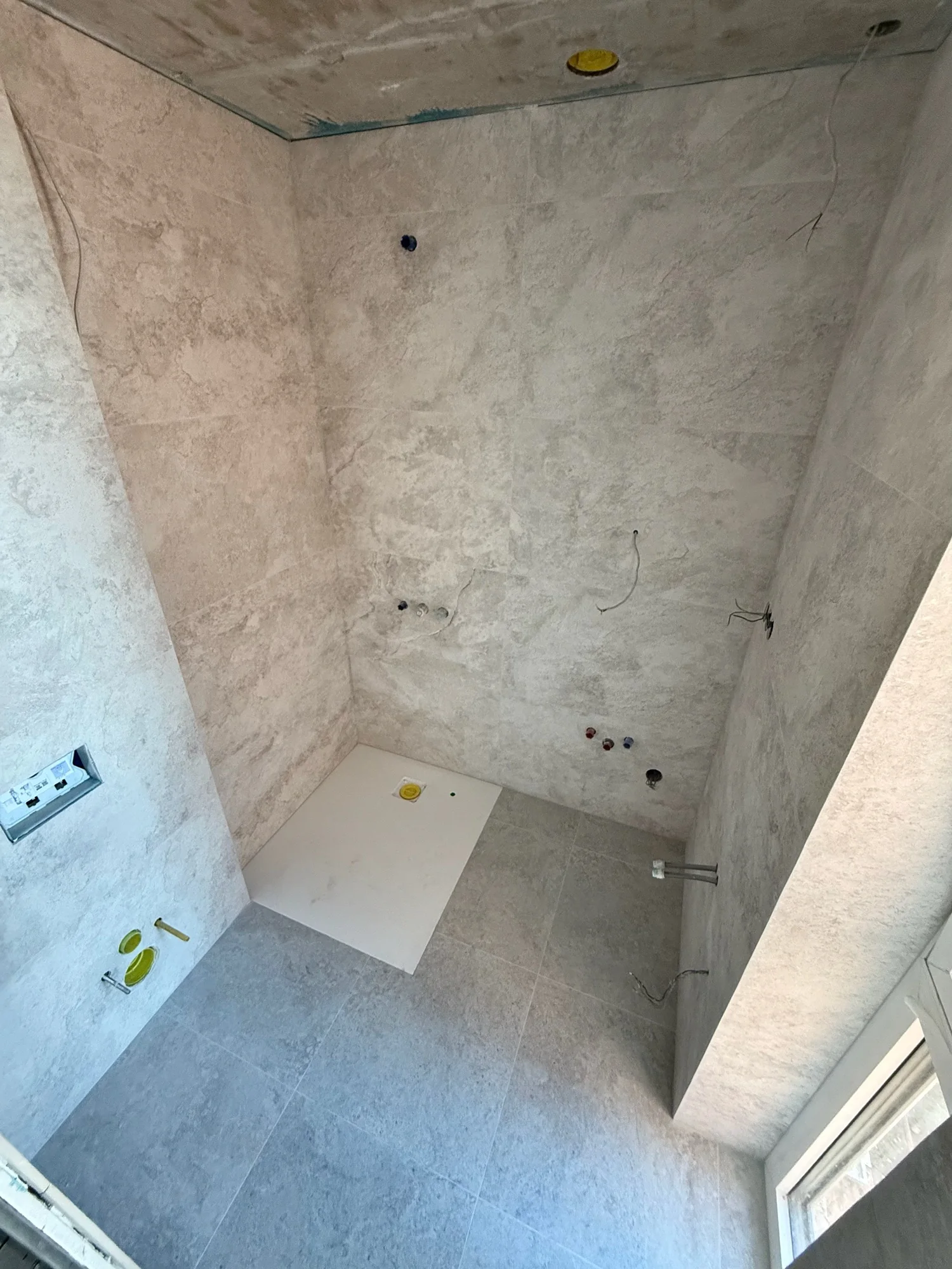 Bathroom wall and floor tiles during installation.